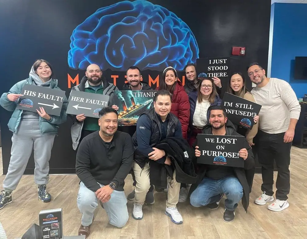 A team holding Titanic, “I’m still confused!?” and “We lost on purpose!” signs under the brain mural